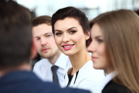 Face of beautiful woman on the background of business people