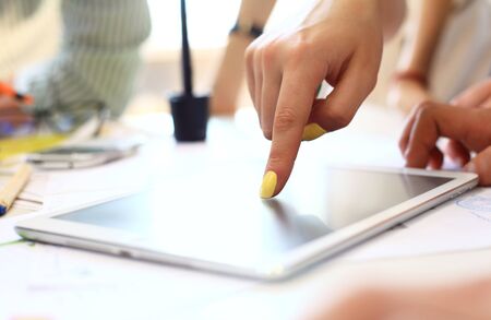 Close-up of female hands touching digital tablet with business diagramの写真素材