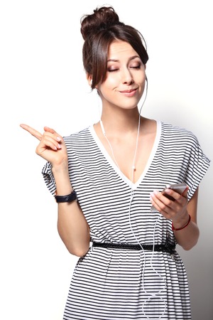 Beautiful woman with headphones, she is listen to the musicの写真素材