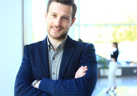 Happy smart business man with team mates discussing in the backgroundの写真素材