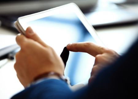 Businessman finger pointing to the screen of a tablet-pc