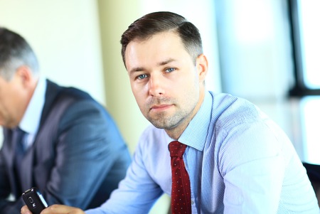 Businessman with colleagues in the background