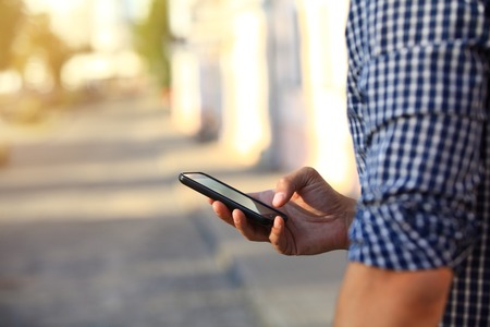 Close up of a man using mobile smart phoneの写真素材