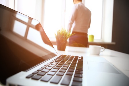 Office workplace with laptop and smart phone on wood tableの写真素材