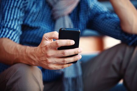Close up of a man using mobile smart phoneの写真素材