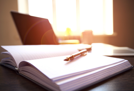 Office workplace with laptop on wood table against the windows.の写真素材