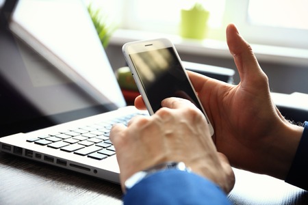 Close up of a man using mobile smart phone