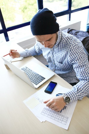 Photo young and talente finance manager working with new project. Handsome man working from his home...