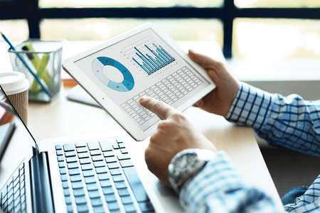 Business adviser analyzing financial figures denoting the progress in the work of the companyの写真素材