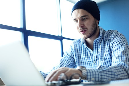 Photo young and talente finance manager working with new project. Handsome man working from his home...