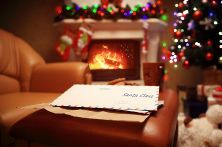 Letter to Santa Claus near the gift and candles. Home decoration.の写真素材