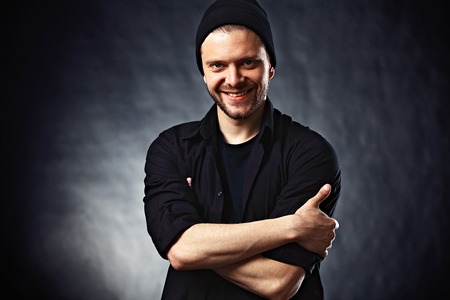 Portrait of young handsome man in t-shirt on blackの写真素材