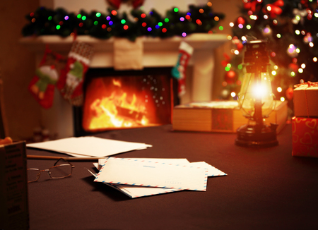 Letter to Santa Claus near the gift and candles. Home decoration.の写真素材