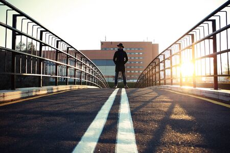 Trendy handsome young man in autumn fashion standing in urban environment.の写真素材