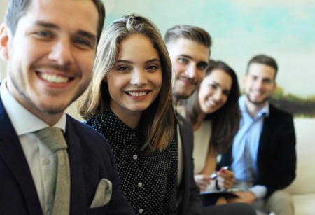 Smiling employees in a line at work.
