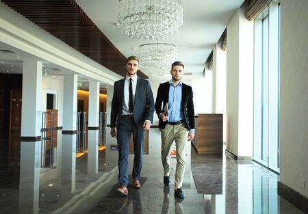 Business people walking in the office corridor.の写真素材