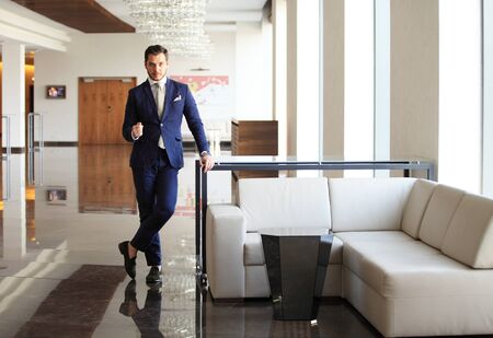 handsome young businessman in a stylish modern officeの写真素材