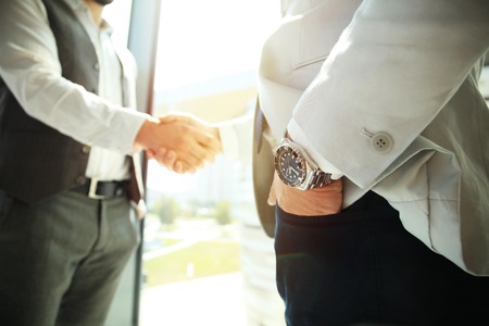 Business people shaking hands, finishing up a meeting.の写真素材