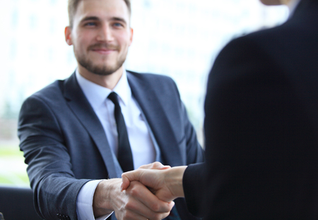 Business people shaking hands, finishing up a meeting.の写真素材