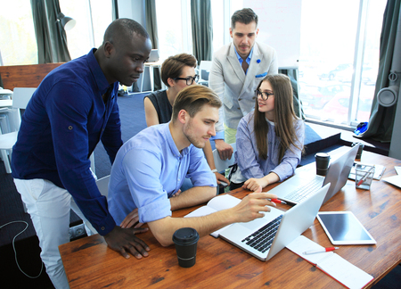 Teamwork concept.Young creative coworkers working with new startup project in modern office.Group of...