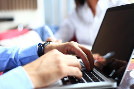 Close-up of typing male handsの写真素材