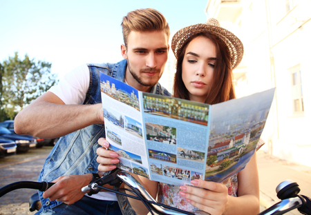 Young loving couple planning their romantic adventure. Joyful young couple smiling.の写真素材
