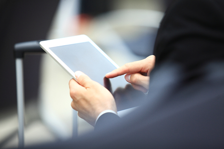 Businessman Using Digital Tablet In Airport Departure Loungeの写真素材