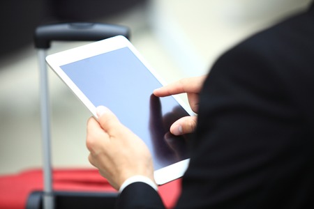 Businessman Using Digital Tablet In Airport Departure Loungeの写真素材