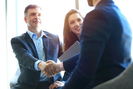 Business people shaking hands, finishing up a meeting.