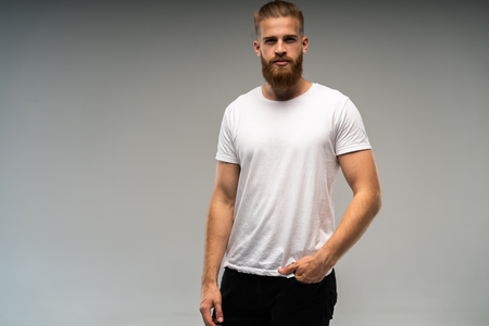 Handsome young guy posing in studio - isolated.の写真素材