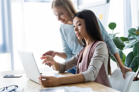 Two female colleagues in office working together.の写真素材
