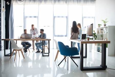 Group of young business people working and communicating together in creative office.の写真素材
