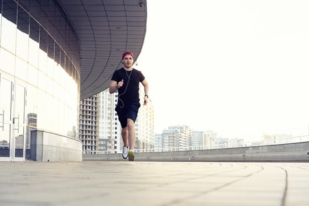 Fit athlete running outdoors to stay healthyの写真素材