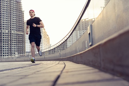 Fit athlete running outdoors to stay healthyの写真素材