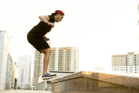 fitness, sport, exercising and people portrait - happy man running upstairs and jumping on stairs.