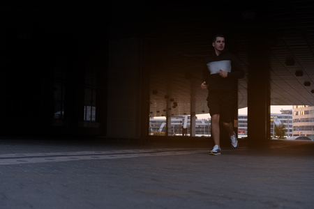 Urban man prepare to jogging in the city. Working out urbanの写真素材