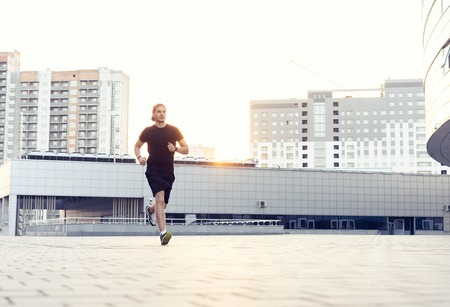 Fit athlete running outdoors to stay healthy