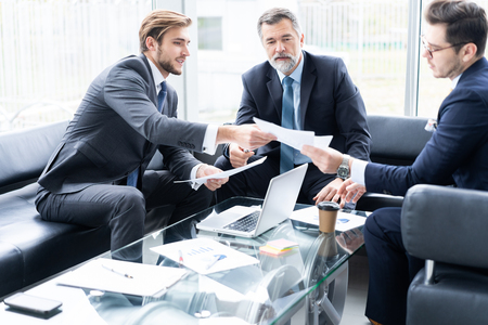 Group of business partners discussing ideas and planning work in office.の写真素材