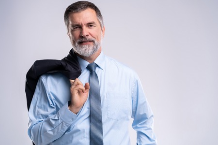 Happy satisfied mature businessman looking at camera isolated on white background.の写真素材