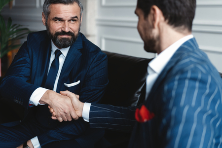 Business people shaking hands, finishing up a meeting.の写真素材