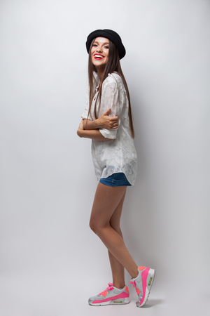 Excited young casual girl having fun. Isolated on white backgroundの写真素材