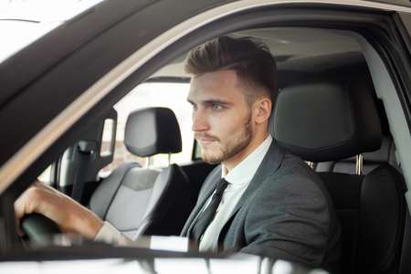 Young business man test drive new car.の写真素材