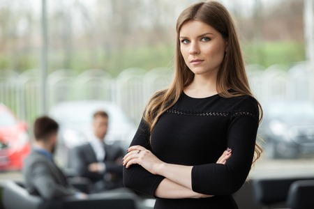 Face of beautiful woman on the background of business people.の写真素材