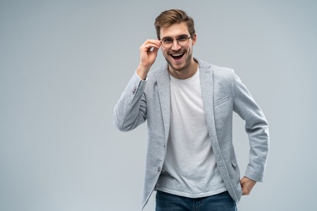 Portrait of young amazed man isolated on gray background.の写真素材