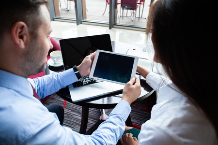 Happy business colleagues in modern office. Team of successful business people having a meeting in executive. Couple in cafe enjoying time together.の写真素材