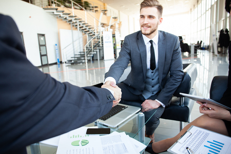 Business people shaking hands, finishing up a meeting.の写真素材