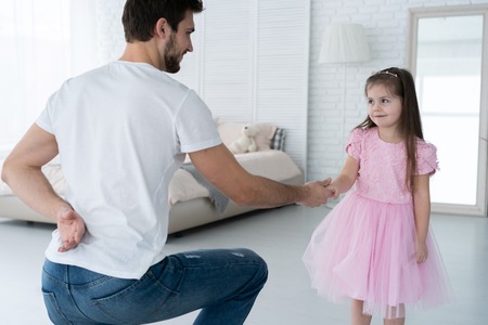 I love you, dad! Handsome young man is dancing at home with his little girl. Happy Fathers Day!の写真素材
