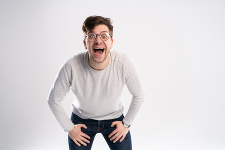 Man with shocked, amazed expression isolated on white backgroundの写真素材