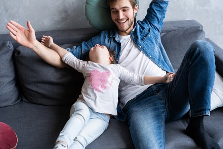 Father with his daughter spending time at home.の写真素材
