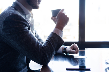 Take a break and have coffee. Business man drinking coffee in a cafe.